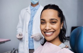 patient smiling while visiting her Aetna dentist