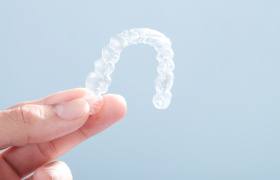 Patient holding clear aligner