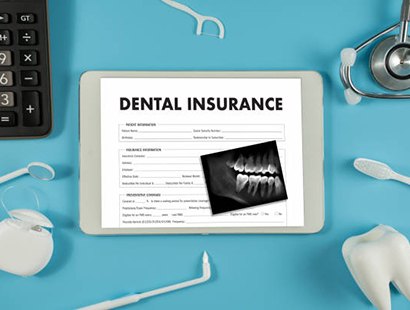 Dental insurance form and X-ray on desk