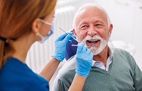 Man smiles at dentist