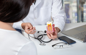 Dentist showing patient anatomy of a tooth